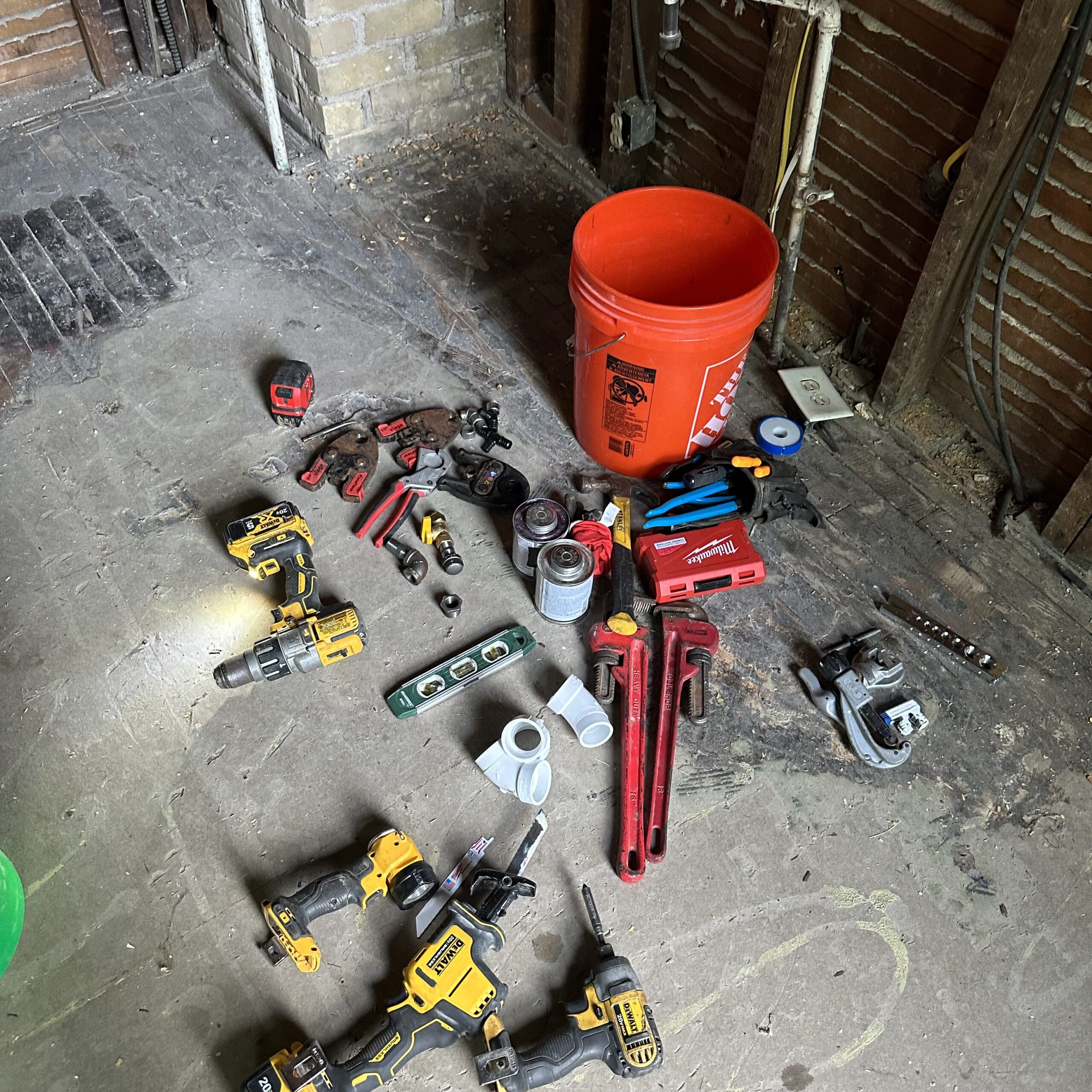 Plumbing, electrical and HVAC tools used during construction of a basement remodel 
